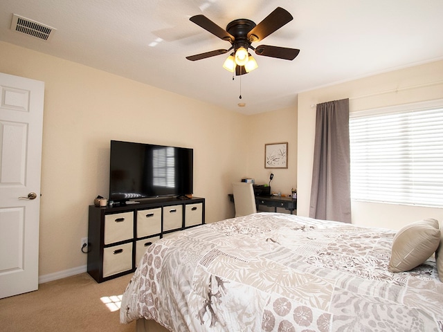 bedroom with light carpet and ceiling fan