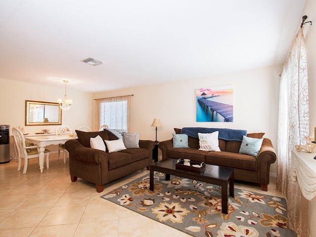 living room featuring an inviting chandelier and light tile patterned floors