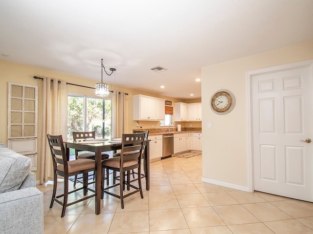 dining area featuring light tile patterned floors and sink