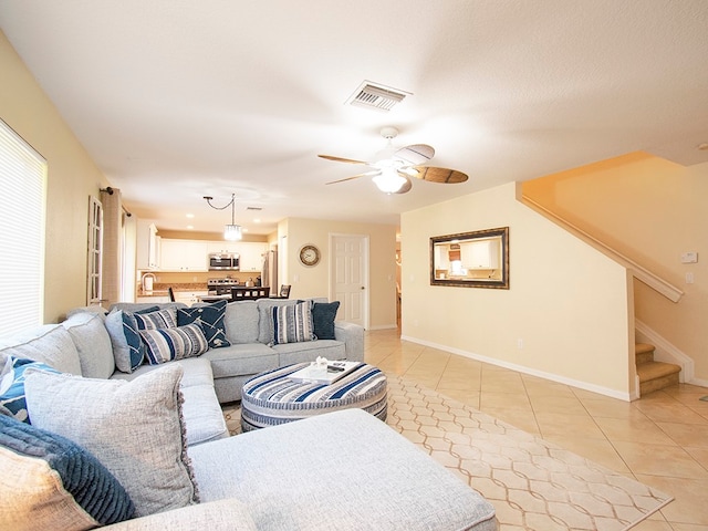 tiled living room featuring ceiling fan