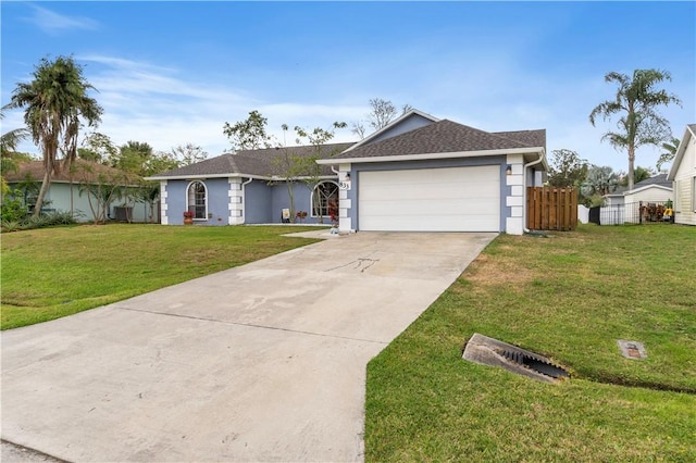 ranch-style home featuring concrete driveway, an attached garage, a front lawn, and fence