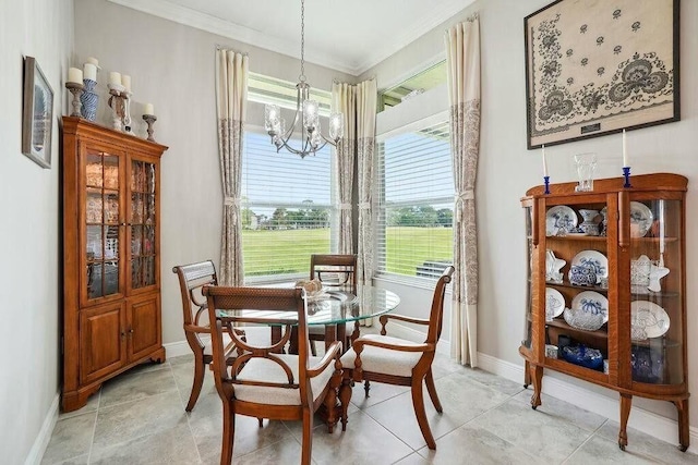 dining area with a chandelier, ornamental molding, and baseboards