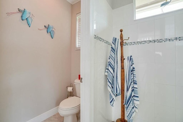 bathroom featuring baseboards and toilet