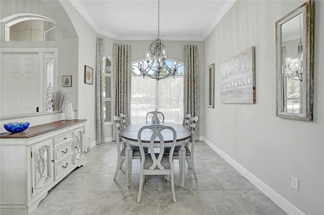 dining room with baseboards, ornamental molding, a notable chandelier, and arched walkways