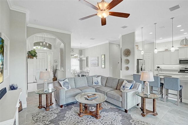 living area featuring light tile patterned floors, visible vents, and crown molding