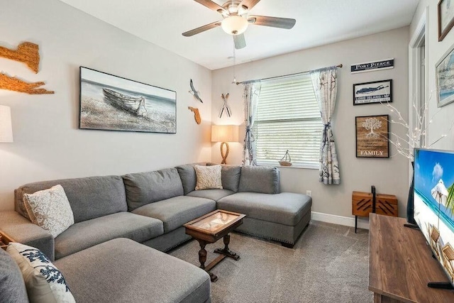 living room with a ceiling fan, baseboards, and carpet flooring