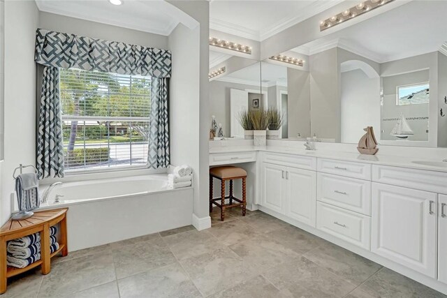 full bathroom featuring double vanity, ornamental molding, a sink, baseboards, and a garden tub