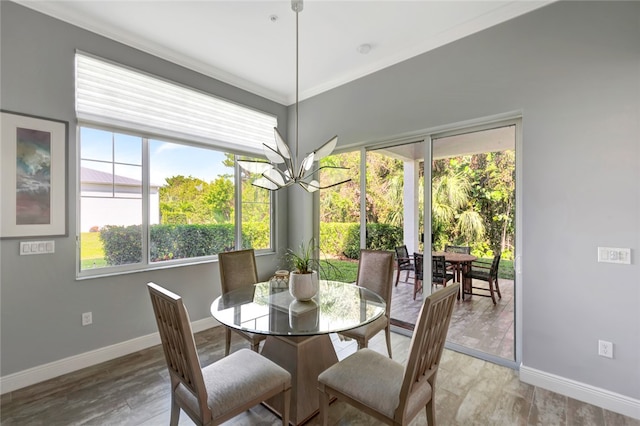 dining area featuring a notable chandelier and crown molding