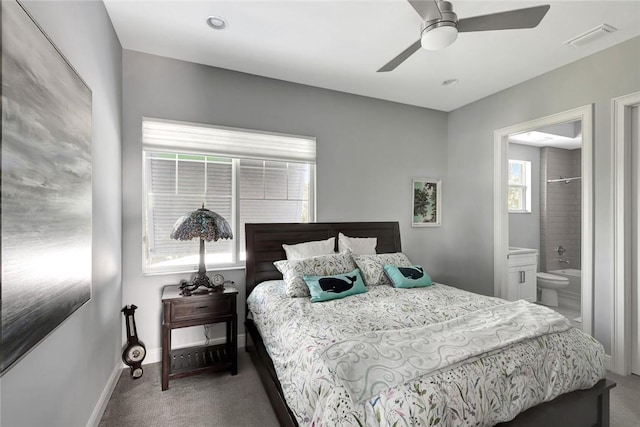 carpeted bedroom featuring ceiling fan and ensuite bathroom