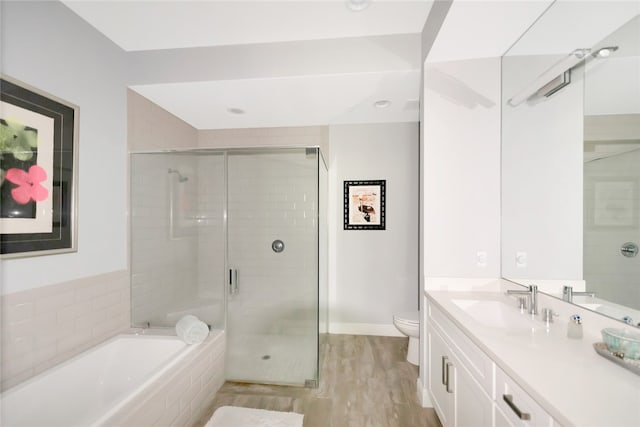 full bathroom featuring toilet, shower with separate bathtub, vanity, and hardwood / wood-style floors