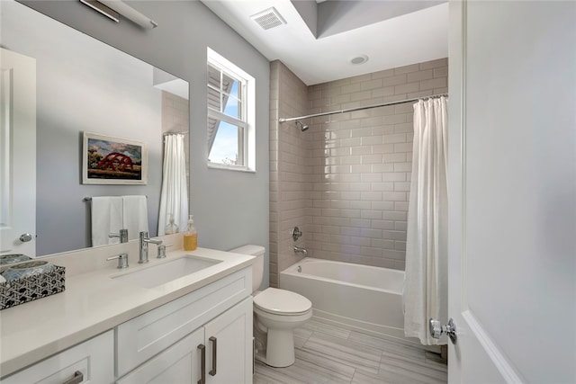 full bathroom with toilet, shower / bathtub combination with curtain, and vanity