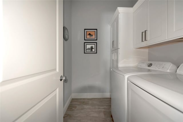 laundry room with washer and dryer and cabinets