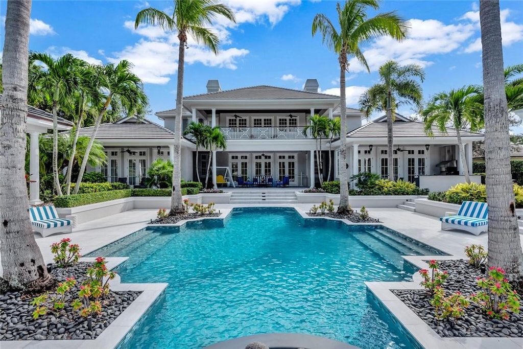 view of swimming pool featuring a patio area and french doors