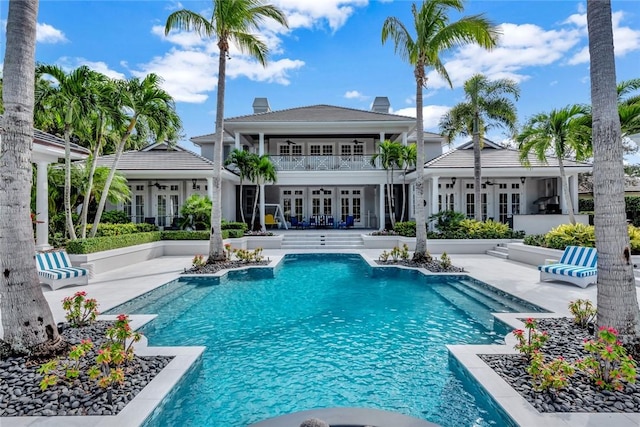 view of swimming pool featuring a patio area and french doors