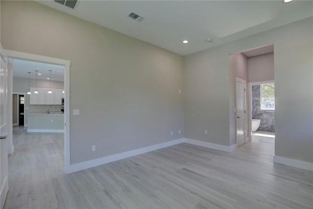 7985 99th Ave, Vero Beach, FL 32967 - empty room featuring light wood-type flooring and recessed lighting