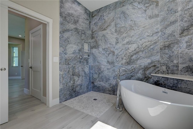 7985 99th Ave, Vero Beach, FL 32967 - full bathroom with wood finished floors and a freestanding bath