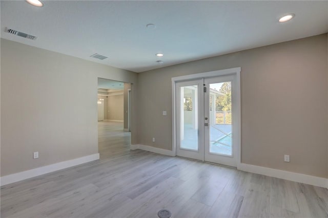 7985 99th Ave, Vero Beach, FL 32967 - spare room featuring french doors, recessed lighting, and wood finished floors