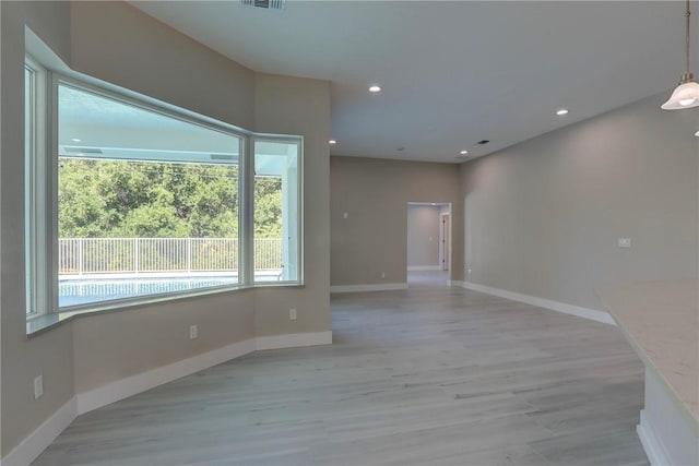 7985 99th Ave, Vero Beach, FL 32967 - empty room with light wood finished floors and recessed lighting