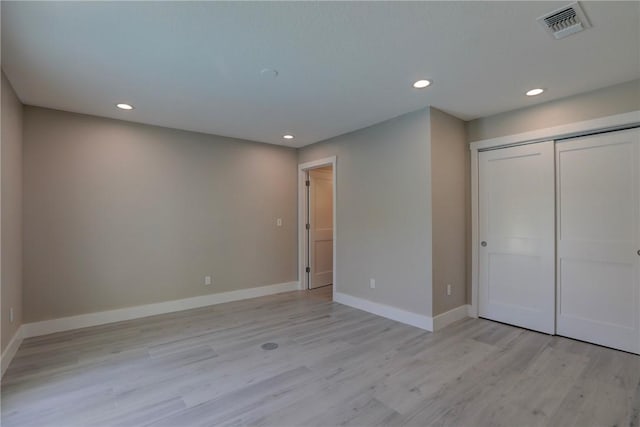 7985 99th Ave, Vero Beach, FL 32967 - unfurnished bedroom with recessed lighting, light wood-style floors, and a closet