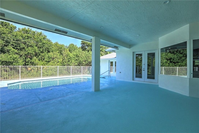 7985 99th Ave, Vero Beach, FL 32967 - view of pool featuring french doors, a patio area, and a view of trees
