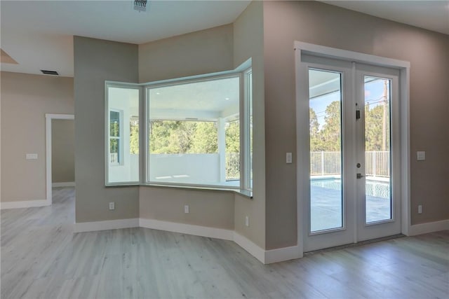 7985 99th Ave, Vero Beach, FL 32967 - doorway to outside with french doors and light wood-style flooring