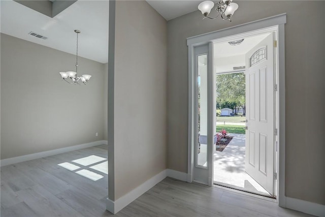 7985 99th Ave, Vero Beach, FL 32967 - foyer with a chandelier and wood finished floors