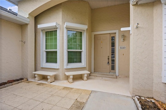 entrance to property with stucco siding