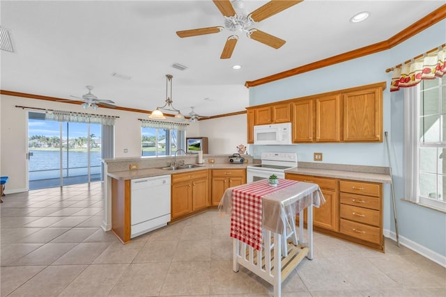 kitchen with visible vents, ornamental molding, a sink, white appliances, and a peninsula