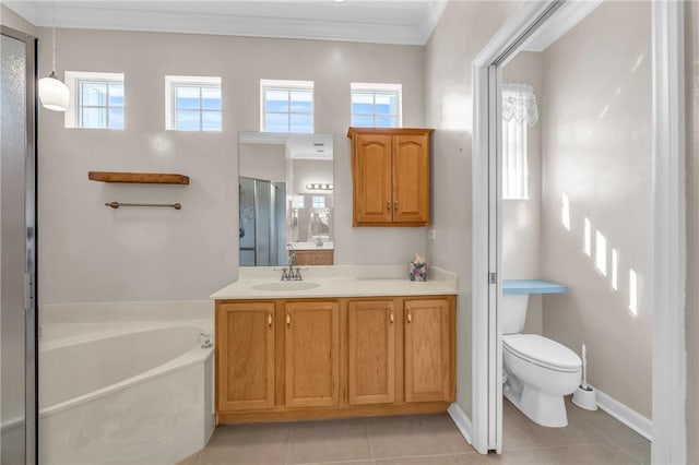 full bath with tile patterned flooring, crown molding, toilet, a garden tub, and vanity