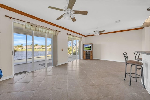 interior space with tile patterned floors, visible vents, baseboards, and ornamental molding