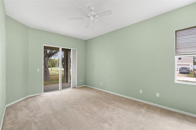 spare room with light carpet and ceiling fan