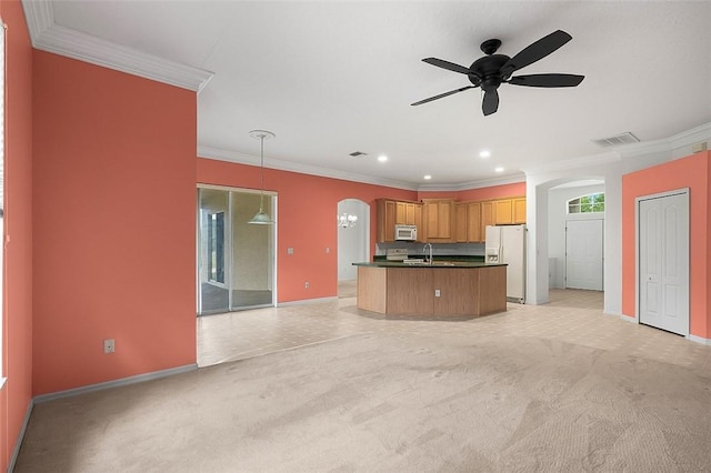 kitchen featuring decorative light fixtures, light colored carpet, white appliances, and crown molding