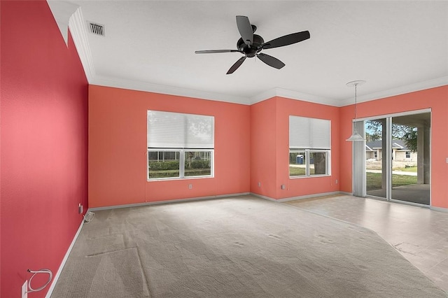 carpeted spare room featuring ceiling fan and ornamental molding