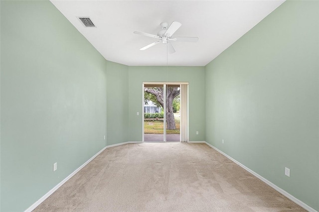 carpeted spare room with ceiling fan