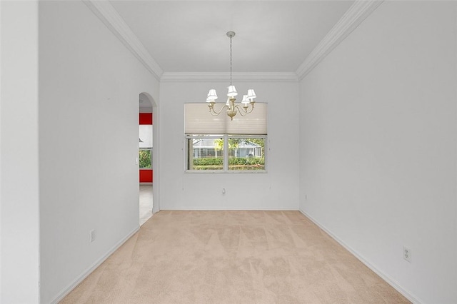 carpeted spare room with crown molding and a notable chandelier