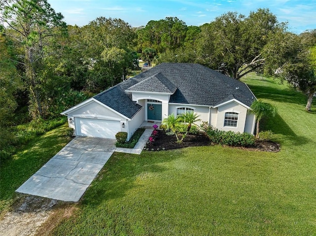 view of front of house with a front yard and a garage