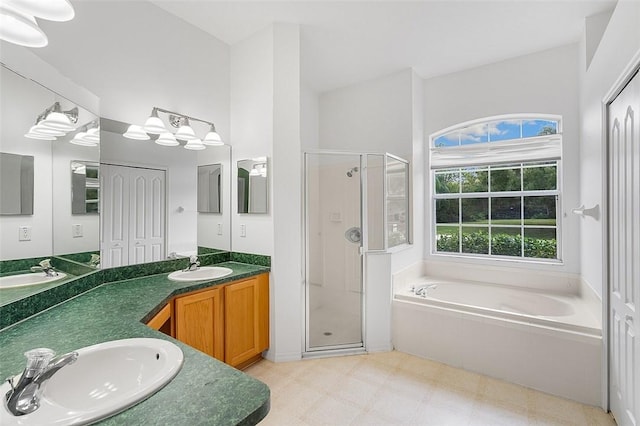 bathroom featuring separate shower and tub and vanity