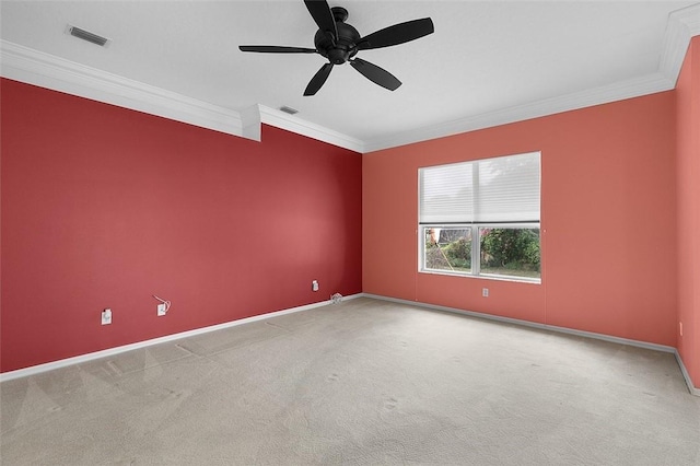 spare room with carpet, ceiling fan, and crown molding