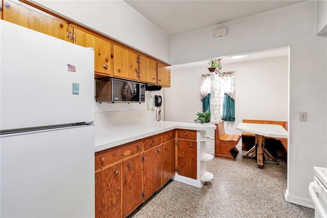 kitchen with stove and white fridge