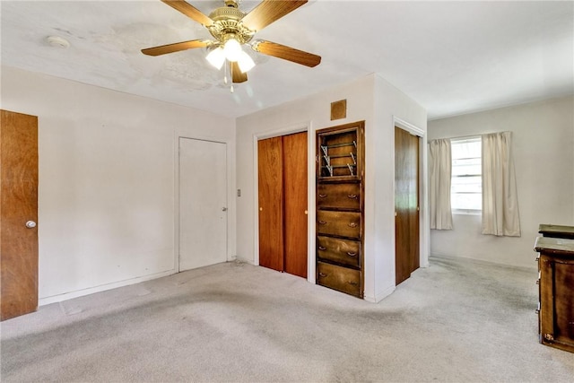 interior space with light carpet and ceiling fan