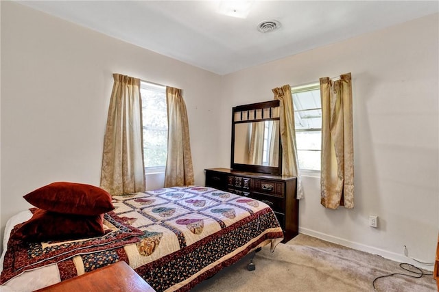 bedroom featuring light carpet