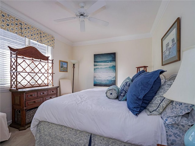 carpeted bedroom featuring ceiling fan and ornamental molding