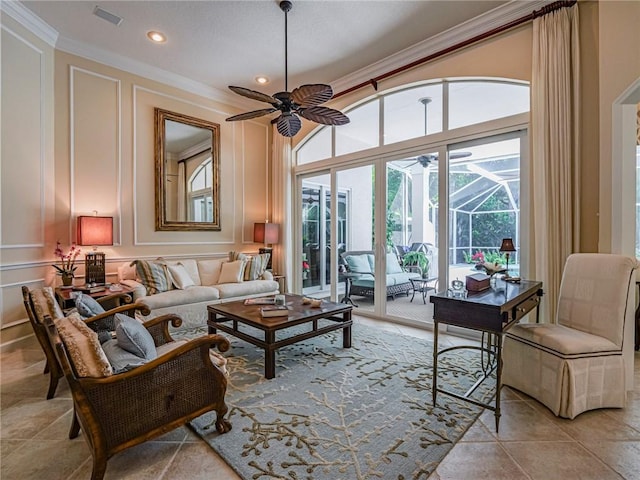 tiled living room with crown molding, ceiling fan, and a high ceiling