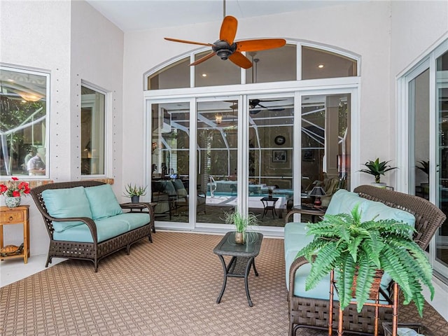 sunroom featuring ceiling fan