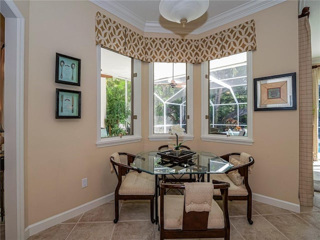 dining area with ornamental molding, a healthy amount of sunlight, and light tile patterned floors