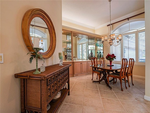 tiled dining space featuring a notable chandelier and crown molding