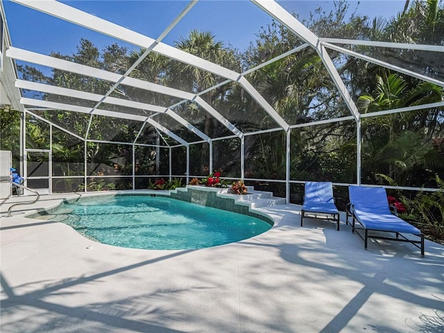 view of pool with a lanai and a patio