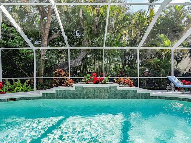 view of swimming pool featuring glass enclosure