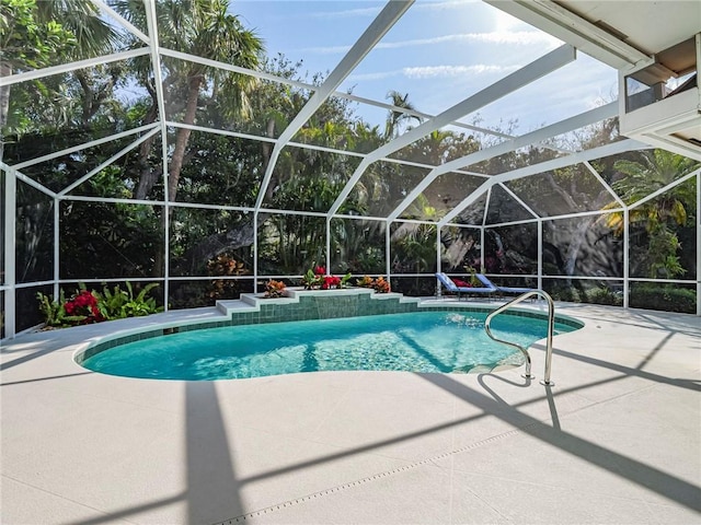 view of swimming pool with a patio area and glass enclosure