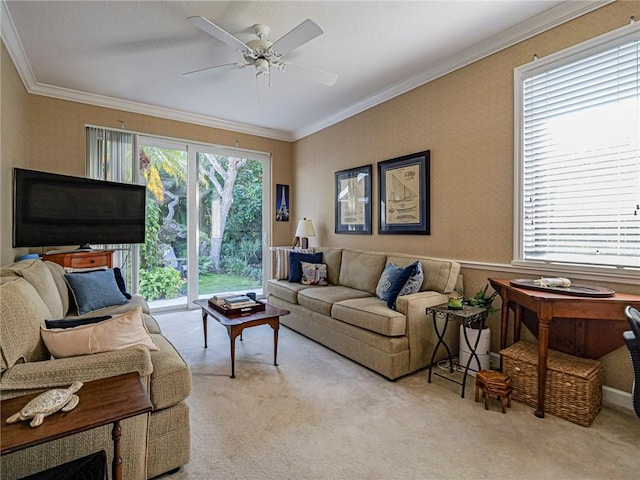 carpeted living room with ornamental molding and ceiling fan